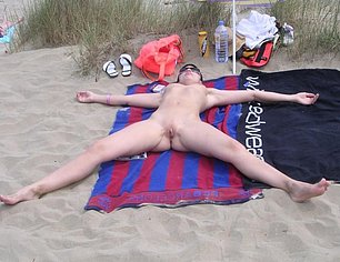BRITISH MATURE SHOWING OFF ON BENCH AT BEACH